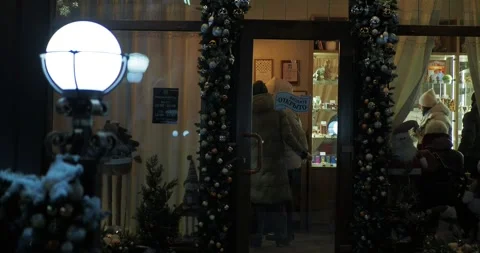 Customers choose goods inside a small store with the inscription "OPEN". Video stock 300761185