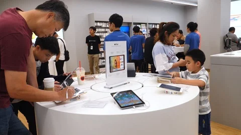 Customers Choosing Ipad Tablets At Apple Store With Children. Stock Footage 100978360