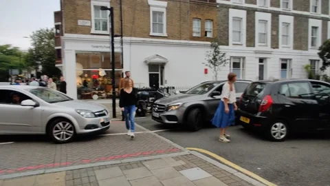 CUSTOMERS FIGHT FOR A PLACE IN THE QUEUE AT THE PETROL PUMP 4K UK Stock Footage 161576740