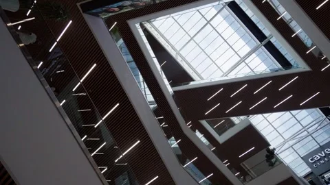Customers going up and down escalators in shopping mall Stock Footage 283757387