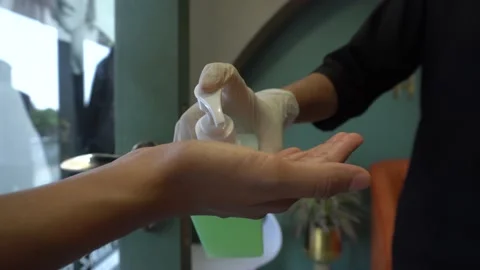 Customers Hands disinfected using hand sanitizer, prevent spread Covid 19 corona Stock Footage 130180401