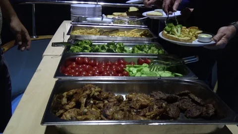 Customers help themself with garnish while meat is served out 3 Stock Footage 112603518