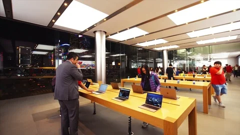 Customers inside the Apple store testing Apple gadgets. Hong Kong, China Stock Footage 84676142