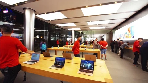 Customers inside the Apple store testing Apple gadgets. Hong Kong, China Stock Footage 84676144