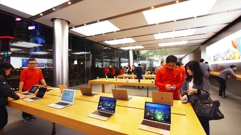 Customers inside the Apple store testing Apple gadgets. Hong Kong, China Stock Footage 84676155