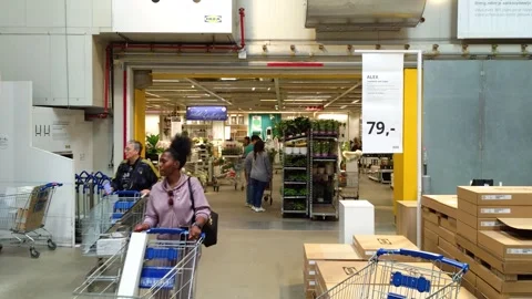Customers leave the last theme compartment in IKEA store with shopping trolleys Stock Footage 345164728