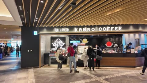 Customers line up at Kanno Coffee inside a modern station. Stock Footage 346012813