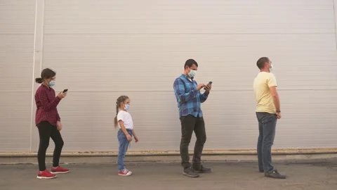 Customers line up in a long line at the social distance. People wear a Stock Footage 144094850