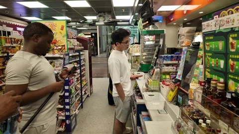 Customers Lining Up and Paying at Convenience Store Counter in China, Evening Stock Footage 337243702