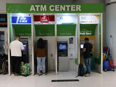 Customers make transactions at atm centre Stock Photos