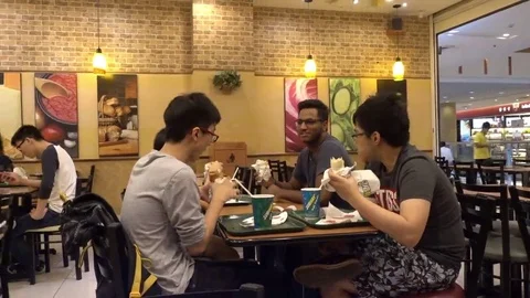 Customers ordering and eating  sandwiches at Subway Restaurant Stock Footage