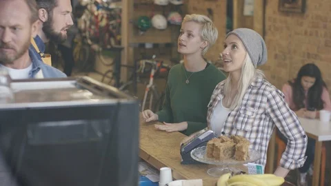 Customers placing order and making payment at counter of coffee shop Video stock 108024463