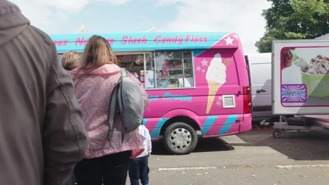 Customers queue at ice cream truck. UK National playday 2023. Family event Stock Footage 247501835