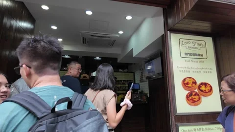 Customers queue outside a bakery in Macau. Stock Footage 333661707