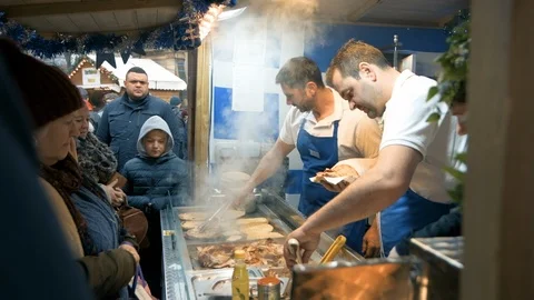 Customers queue up for tasty looking Greek Gyros at Sheffield Christmas Market Stock Footage 120633697