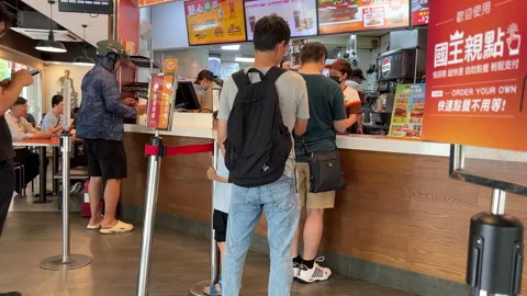 Customers Queuing at Fast Food Restaurant Counter to Place Orders Stock Footage 340540834