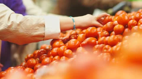 Customers select tomatoes in supermarket Stock Footage 21248136