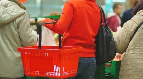 Customers select tomatoes in supermarket Stock Footage 21248228
