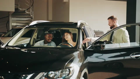 Customers sitting in car and examining all details of interior. Salesman Stock Footage 174705029