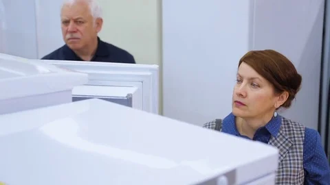 Customers in the store choosing a new refrigerator Stock Footage
