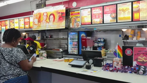 Customers wait at the counter inside Ben’s Video stock 324753196