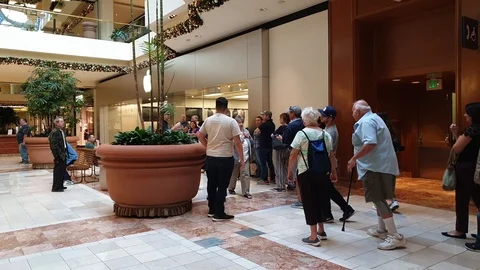 Customers waiting to enter Apple Store Stock Footage 98819780