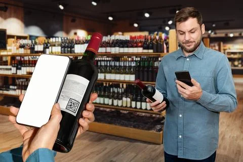 Customers in a wine store scan e-label of wine bottles and reading informatio Stock Photos