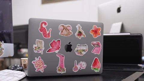 Customized Apple MacBook with colorful stickers in office Stock Footage 336762959