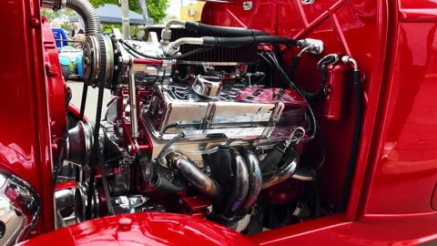 Customized red car engine showcased at outdoor event Stock Footage 313866396