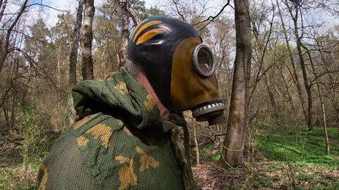 Customized Soviet gas mask GP-5, vintage, camouflage military jacket. Video stock 333470418