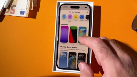 Customizing Lock Screen: iPhone 15 Pro Setup Stock Footage 269500488