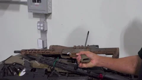 Customs Border Protection (CBP) personnel inspecting confiscated firearms Stock Footage 333680897