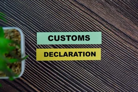 Customs Declaration write on sticky notes isolated on Wooden Table. Stock Photos