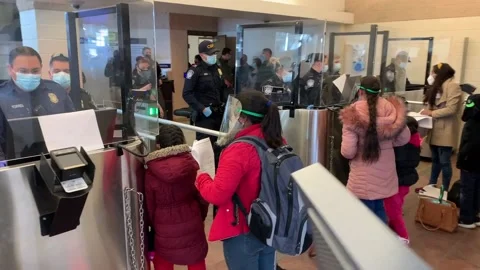 Customs officers processing migrants with active MPP cases at Texas Center Stock Footage 150425863