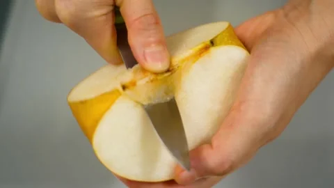 Cut and remove seeds from a pear. Asian pears, nashi pear, organic fruit Video stock 320109293
