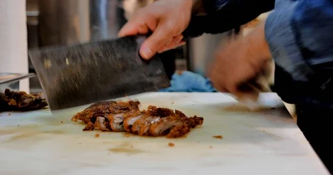 Cut and slice fried crispy chicken or duck on white plastic chopping block. Stock Footage 119133335