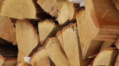 Cut and split firewood with snow falling Stock Footage 994323