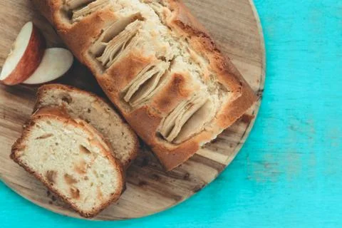 Cut apple cake on a blue background. Copy space. Baking concept. Stock Photos