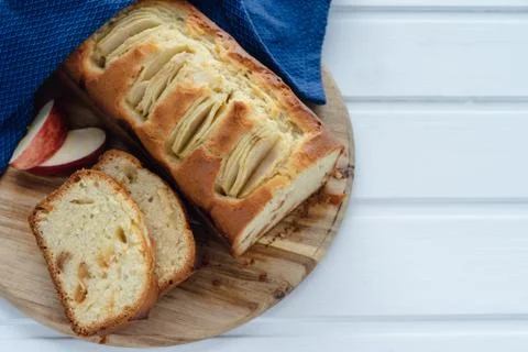 Cut apple cake on a white background. Copy space. Baking concept. Stock Photos