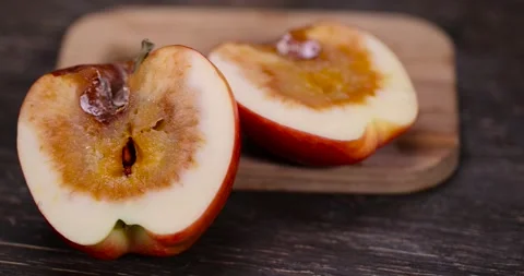 Cut apple that has begun to deteriorate and become covered with rot due to long Stock Footage 309894696
