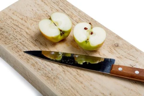Cut apple with a knife on a white background Stock Photos