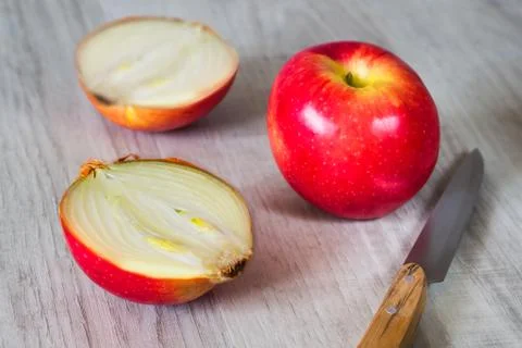 Cut apple with onions inside. Stock Photos