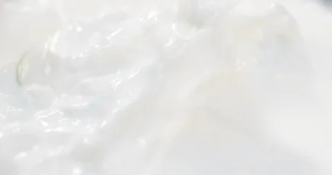 Cut Apples falling in Milk Yogurt 4K Stock Footage 124736763