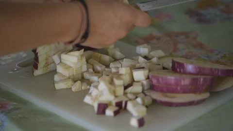 Cut the aubergines for diced Stock Footage 93448351