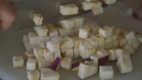 Cut the aubergines for diced Stock Footage 93449097