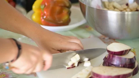 Cut the aubergines for diced Stock Footage 93462435