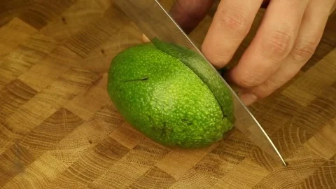 Cut the avocado with a sharp knife Stock Footage 73482819