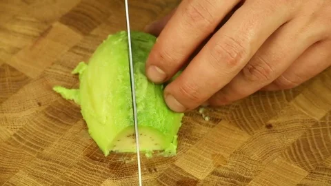 Cut the avocado with a sharp knife Stock Footage 73482894