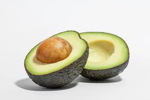 Cut avocado on white background Stock Photos