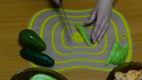 Cut avocados into pieces and stack in a plate Stock Footage 122323244